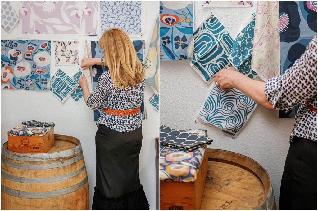 woman pining blue fabric swatches to a wall photographed by Krista Marie Photography, a Bay Area personal brand photographer