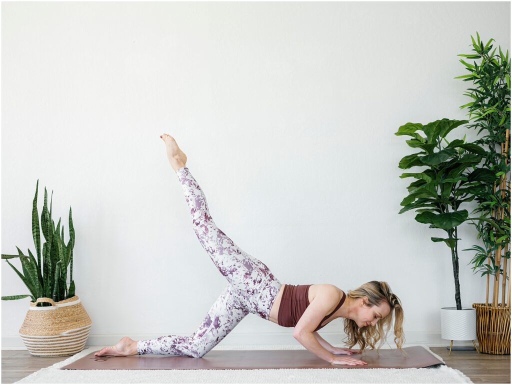 woman practicing yoga indoors with plants by Krista Marie Photography, a Bay Area brand photographer